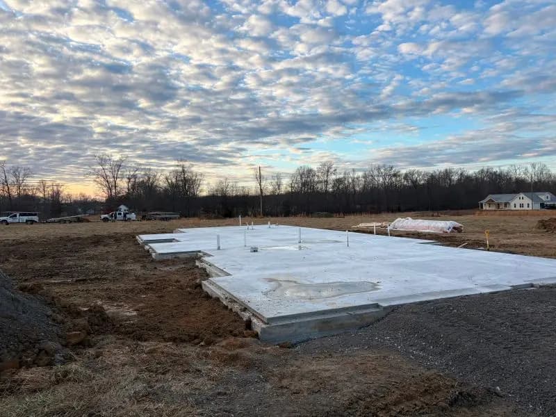 Finished concrete slab on a cleared building site at dusk