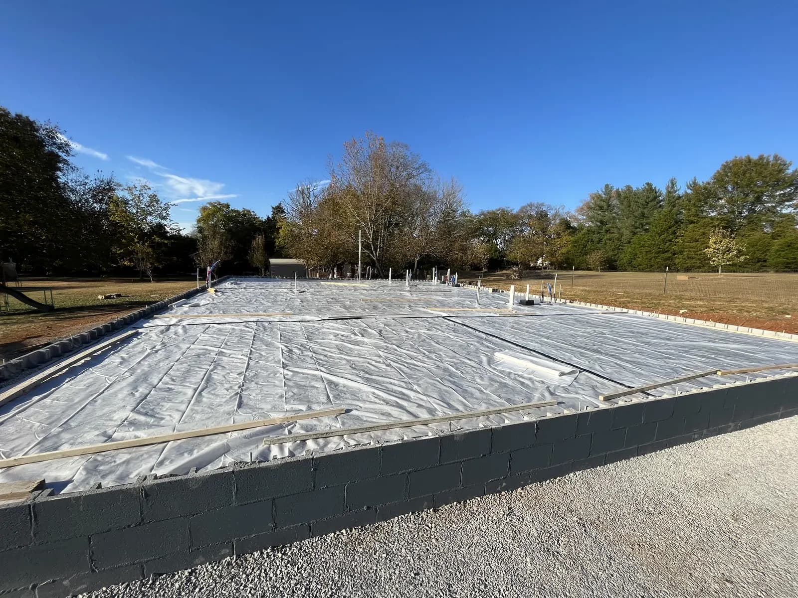 New concrete slab on a block foundation covered while it cures
