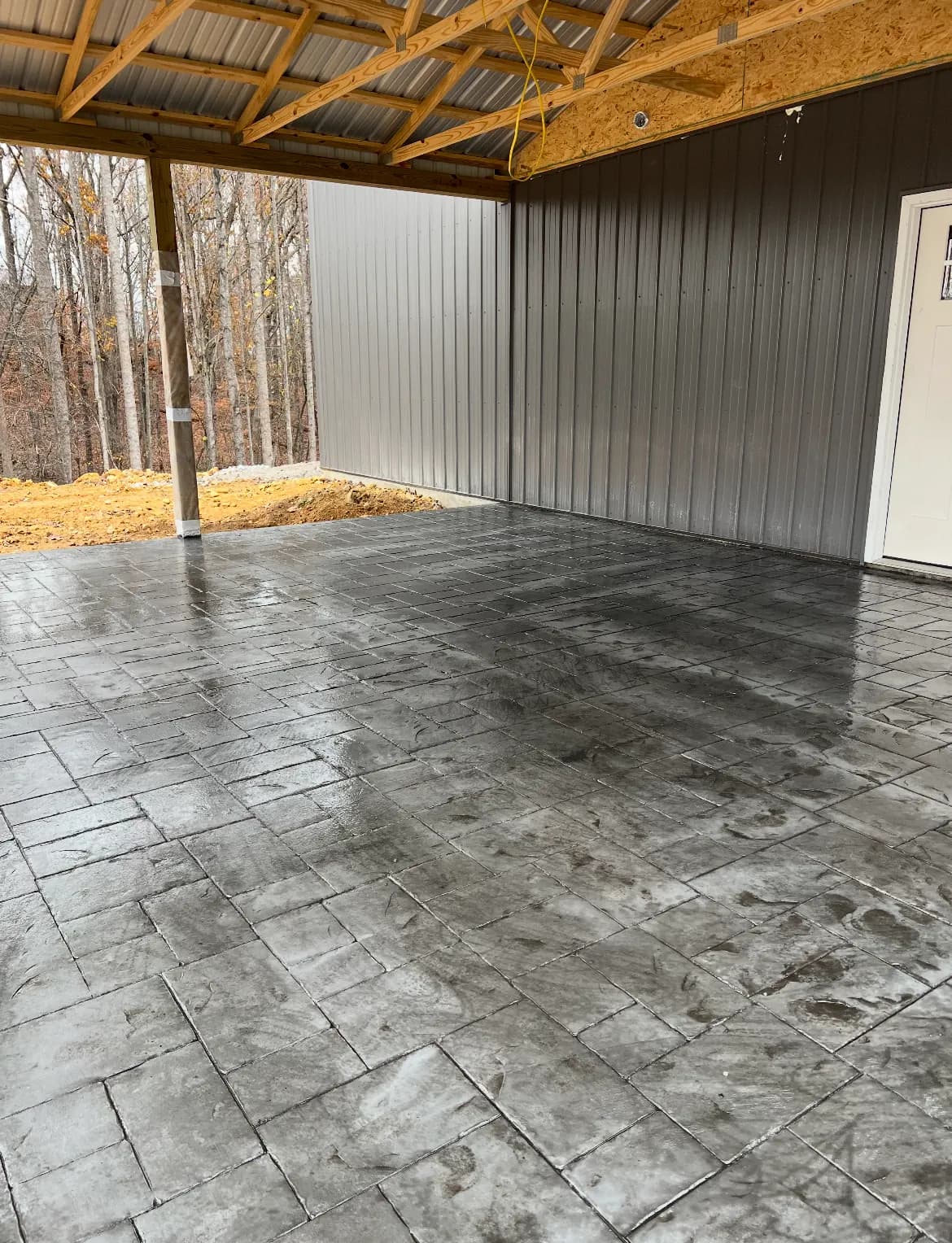 Gray stamped concrete floor under a covered outdoor pavilion